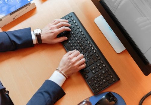 person-typing-on-computer-keyboard-2058128