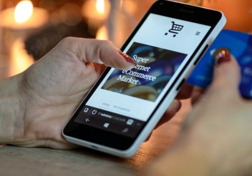 person-using-black-and-white-smartphone-and-holding-blue-230544